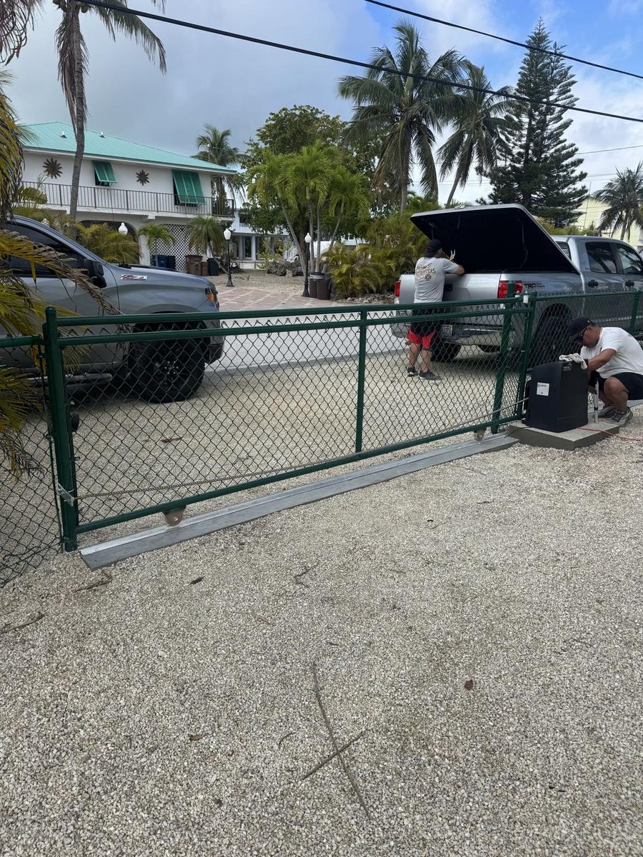 Green vinyl coated chain link fence with a matching slide gate