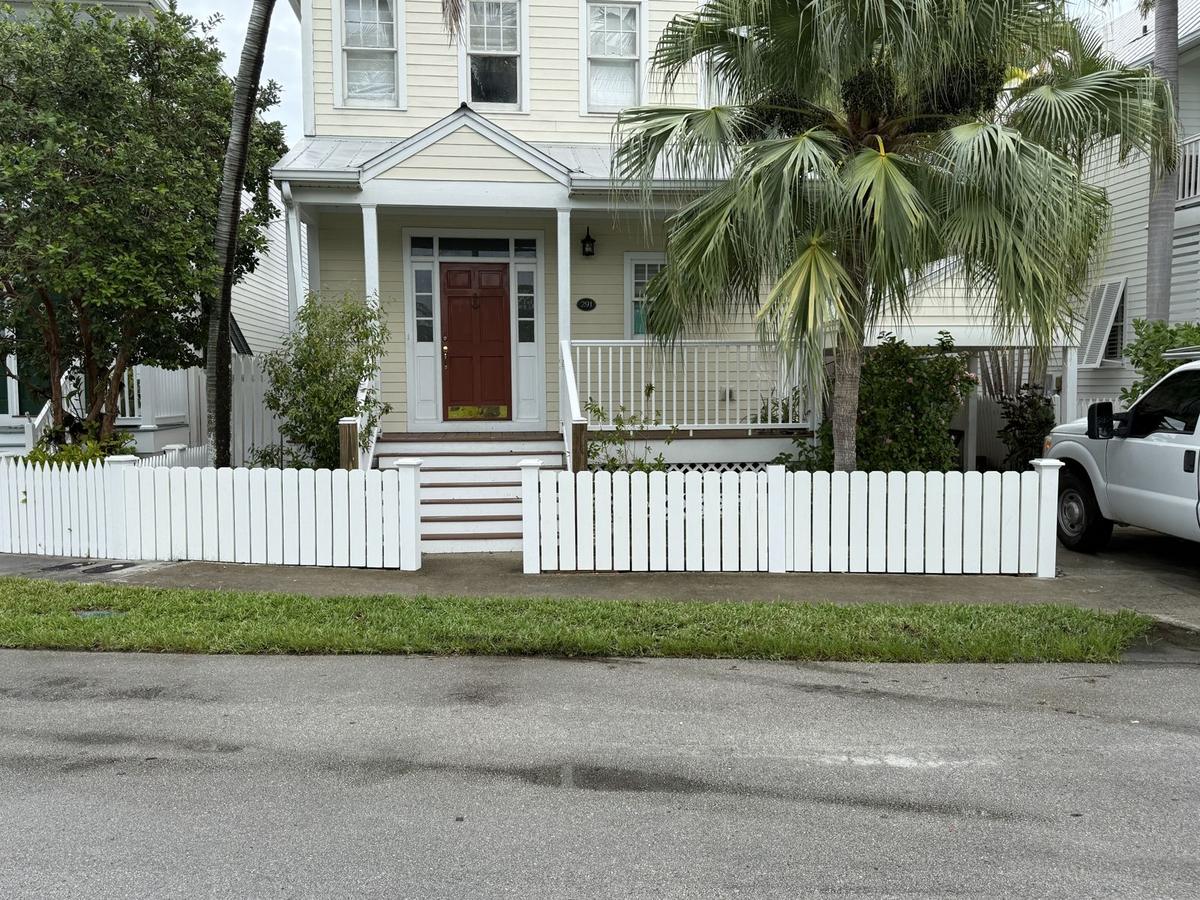 White picket fence in front of a Keys home